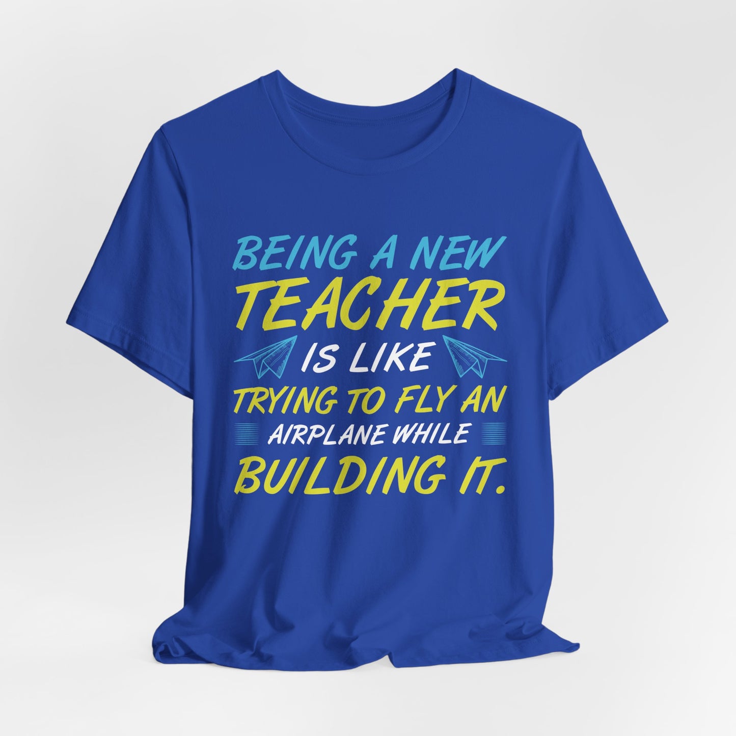 Being A New Teacher Is Like Trying  To Fly An Airplane While Building It - Unisex Jersey Short Sleeve Tee