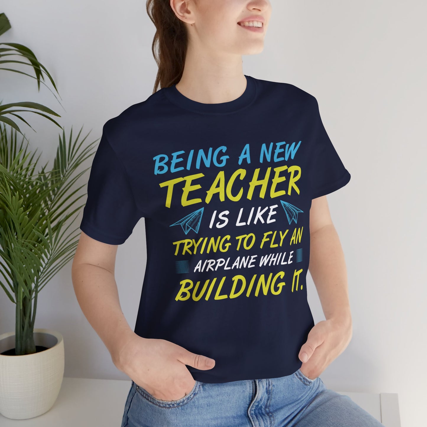 Being A New Teacher Is Like Trying  To Fly An Airplane While Building It - Unisex Jersey Short Sleeve Tee