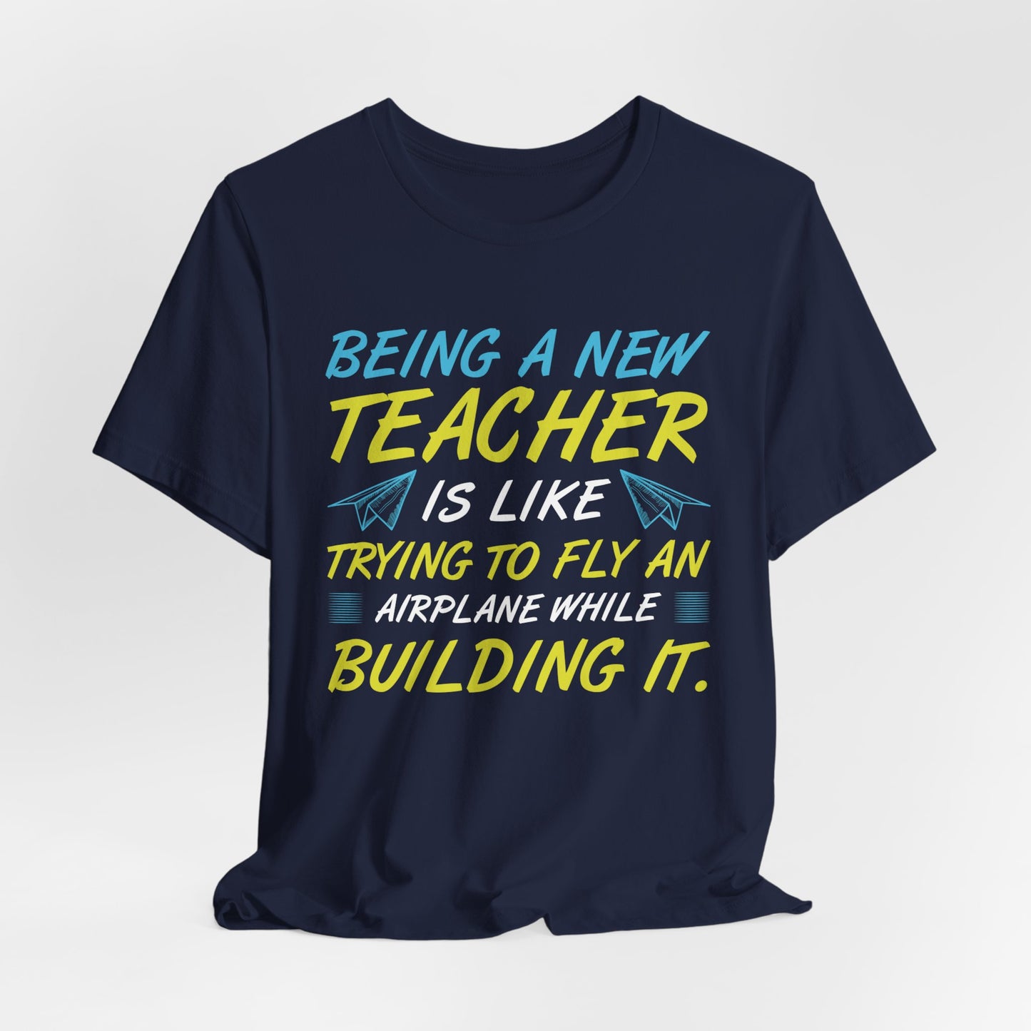 Being A New Teacher Is Like Trying  To Fly An Airplane While Building It - Unisex Jersey Short Sleeve Tee